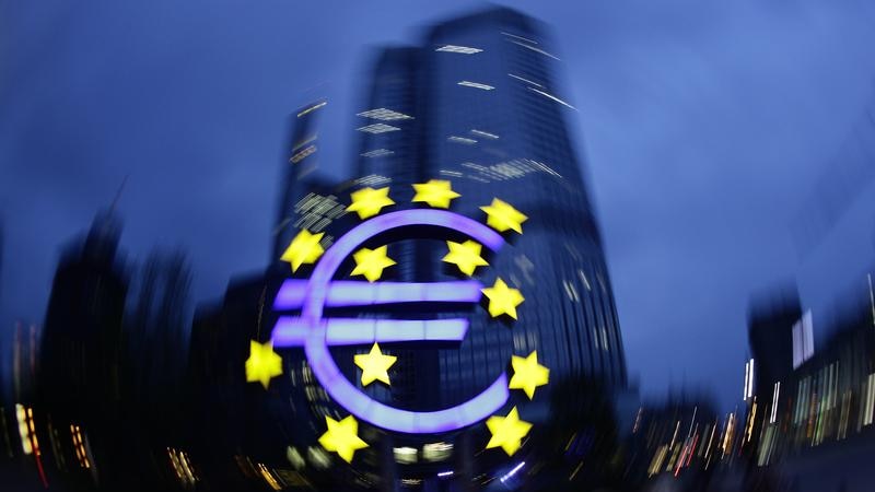 The illuminated euro sign is seen in front of the headquarters of the European Central Bank