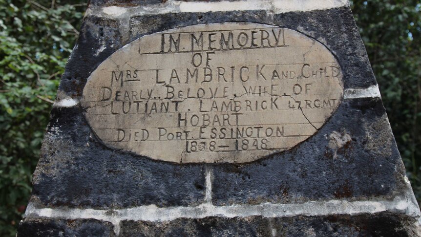 A closeup of a gravestone that reads, 'In loving memory of Mrs Lambrick and child'.