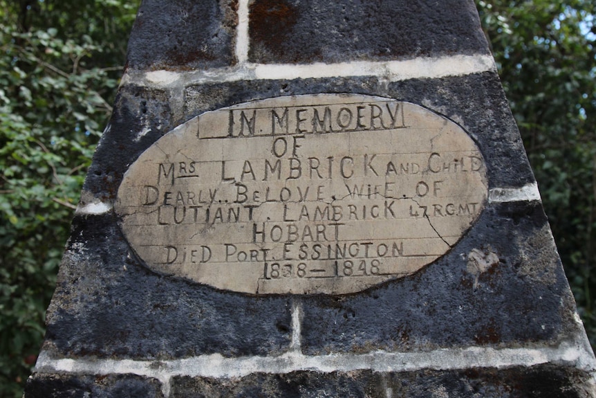A closeup of a gravestone that reads, 'In loving memory of Mrs Lambrick and child'.