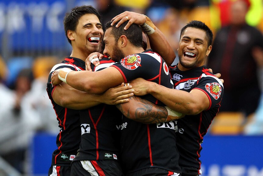 Feleti Mateo and his Warriors team-mates celebrate his try against the Gold Coast.