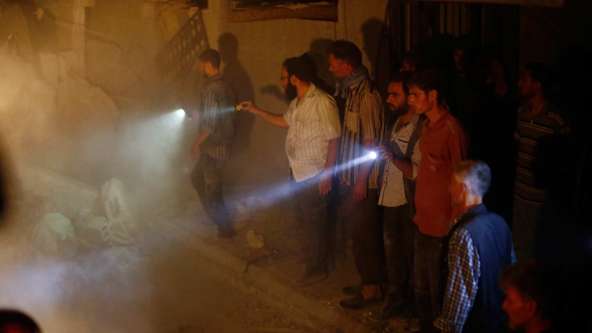 Rescue workers search for victims after Syrian government bombing