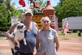 A couple and their small dog Bob stand in Larrimah. 