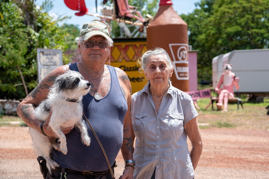 A couple and their small dog Bob stand in Larrimah. 