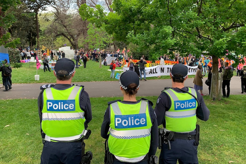 Police watching climate protesters in Melbourne's Carlton Gardens