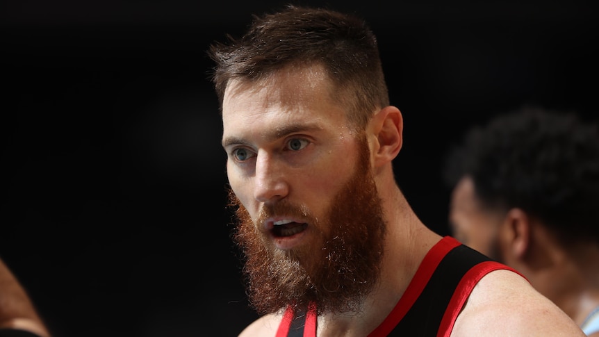 A Toronto Raptors NBA player looks on during a break in a game.