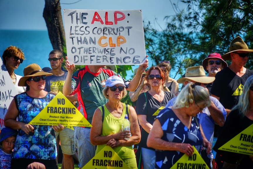 A placard says 'The ALP: Less corrupt than the CLP otherwise no difference'