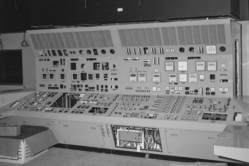 A black and white photo of a large switching unit, covered in dials and switches.