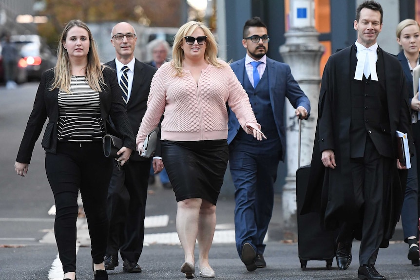 Rebel Wilson leaves the Supreme Court surrounded by her legal team.