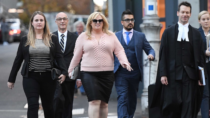 Rebel Wilson leaves the Supreme Court surrounded by her legal team.