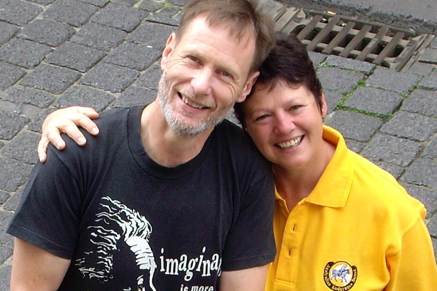 A happy man and woman holding each other close and smiling