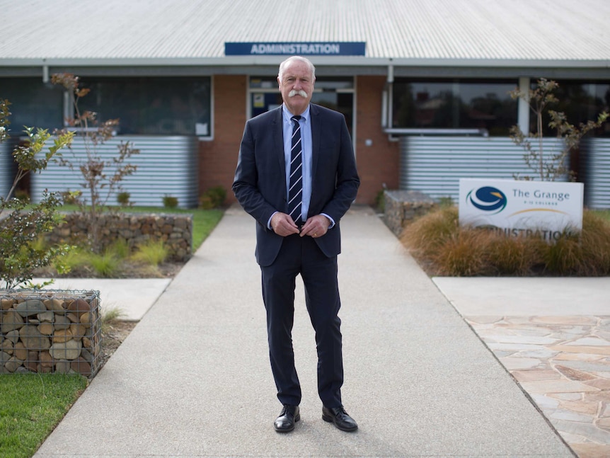 David Smillie stands in front of The Grange administration office.