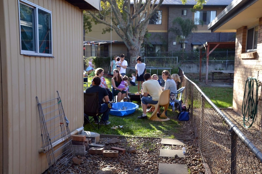 People gather in Julian Scharf's backyard during a party