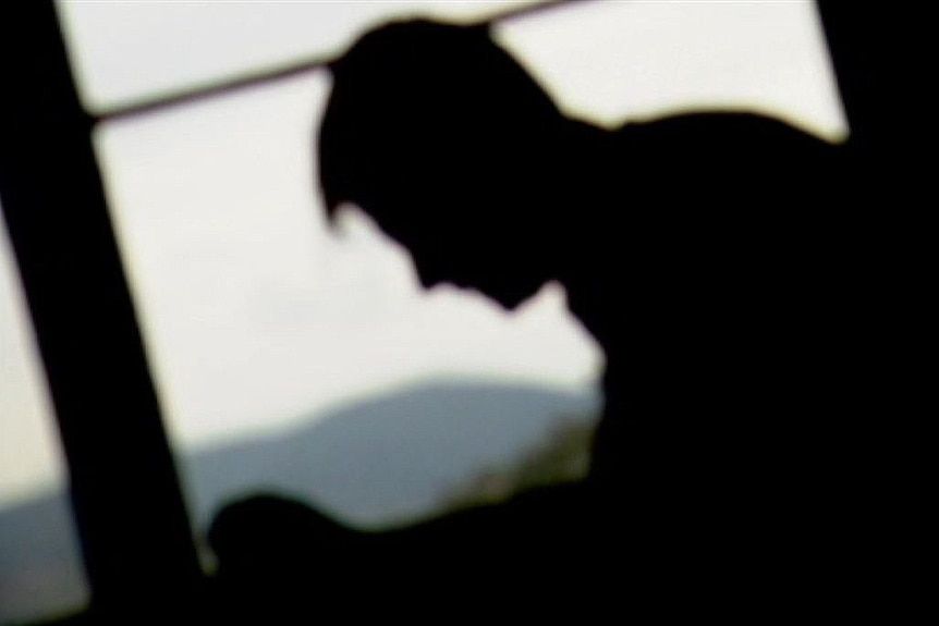 Young male silhouetted against window generic image.