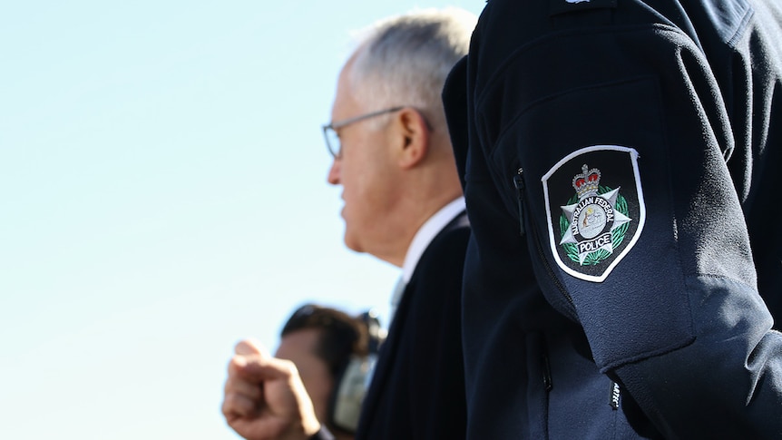PM Malcolm Turnbull clenches a fist as he announces funding for the AFP.