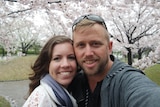 A selfie photo of a happy young couple outside in Japan.