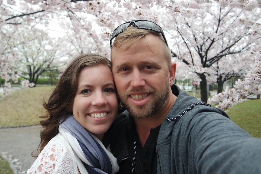 A selfie photo of a happy young couple outside in Japan.