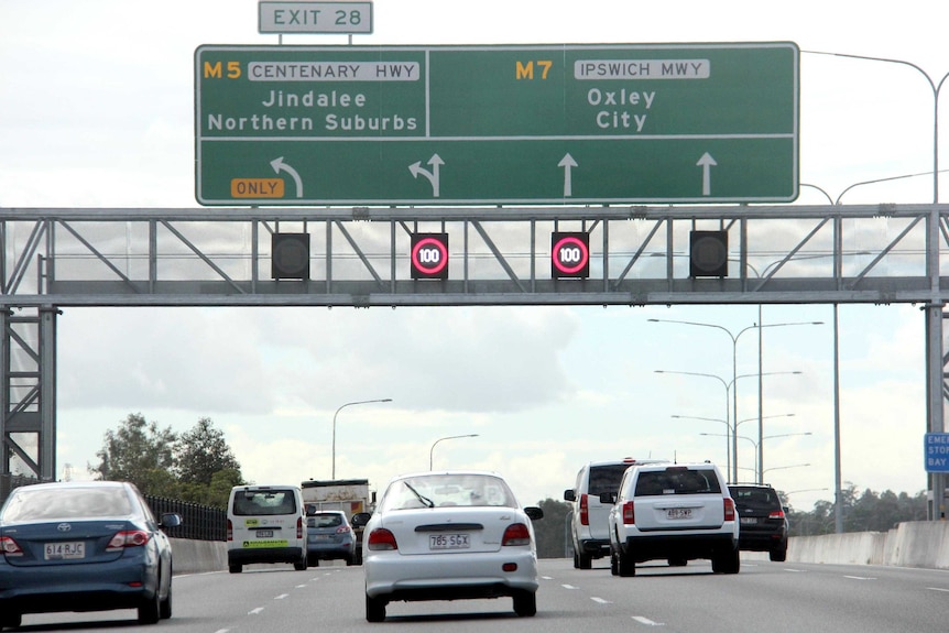 Vehicles travel along the Ipswich Motorway approaching the Centenary Highway exit.