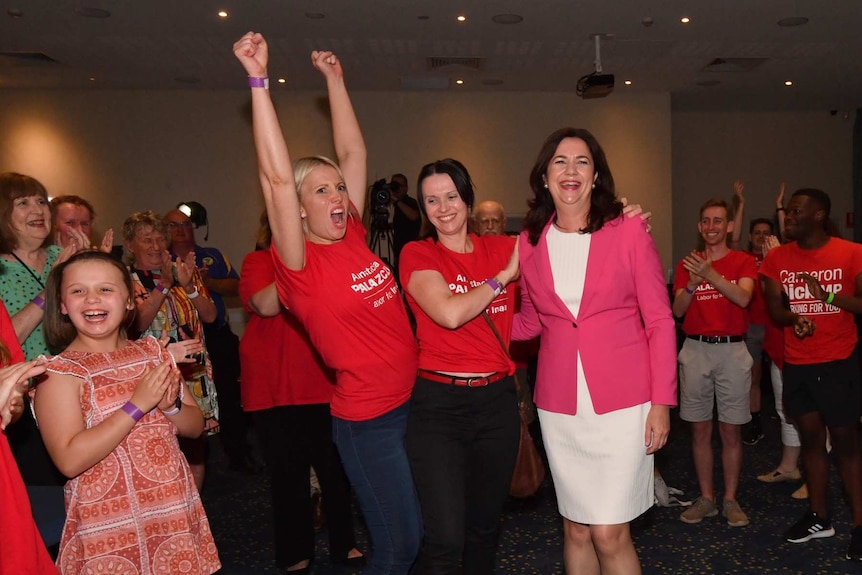 A woman is congratulated by people clapping.