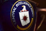 The Central Intelligence Agency (CIA) logo is reflected in glasses