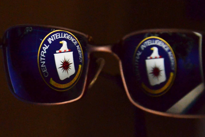 The Central Intelligence Agency (CIA) logo is reflected in glasses