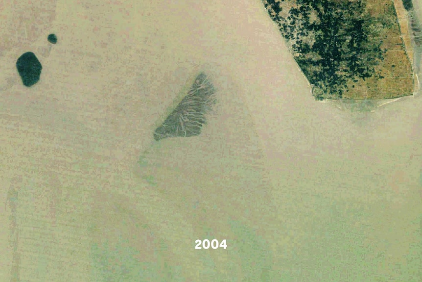 A satellite images of a small island, part of it is underwater