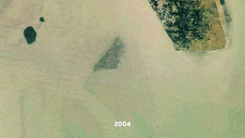 A satellite images of a small island, part of it is underwater
