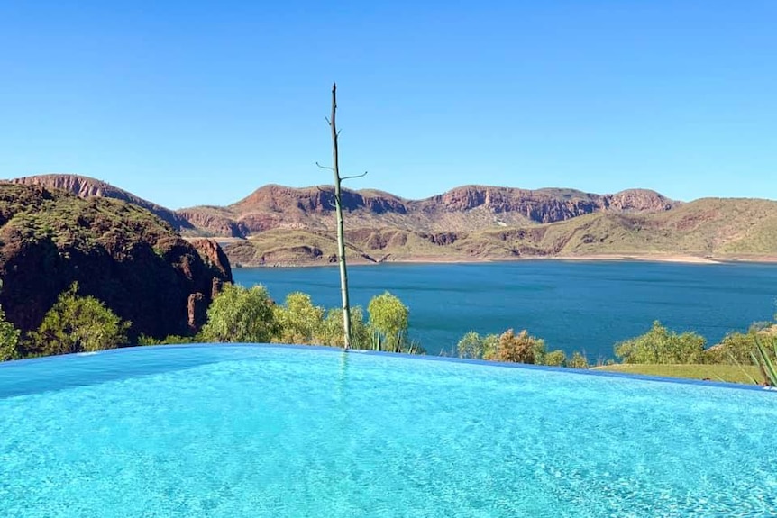 A blue pool overlooks red ranges and a navy lake
