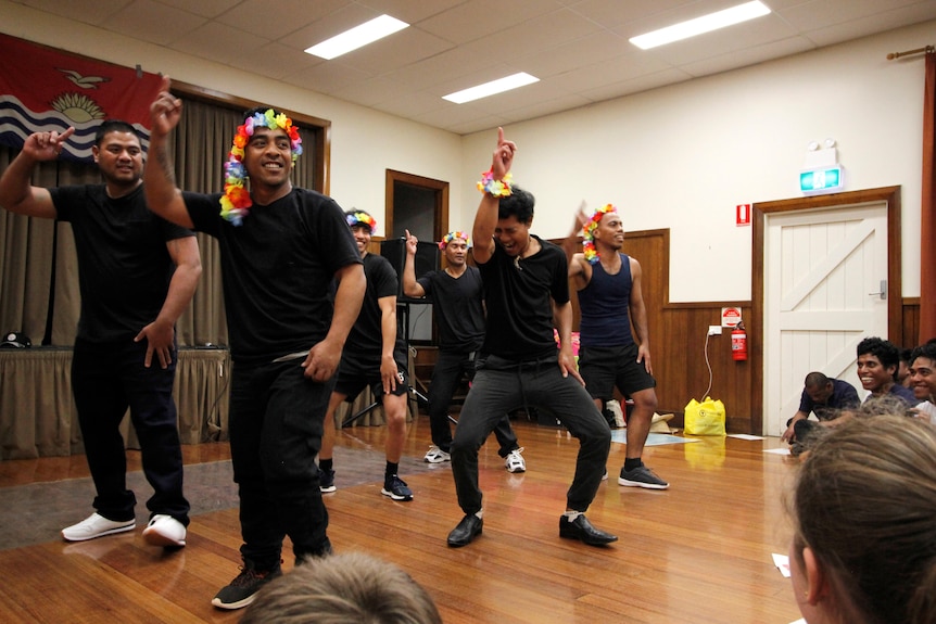A group of Kiribati workers dance in a Tasmanian community hall