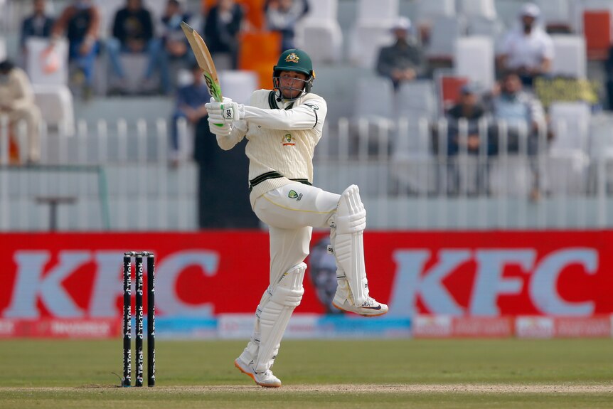 Usman Khawaja lifts his front knee as he plays a pull shot