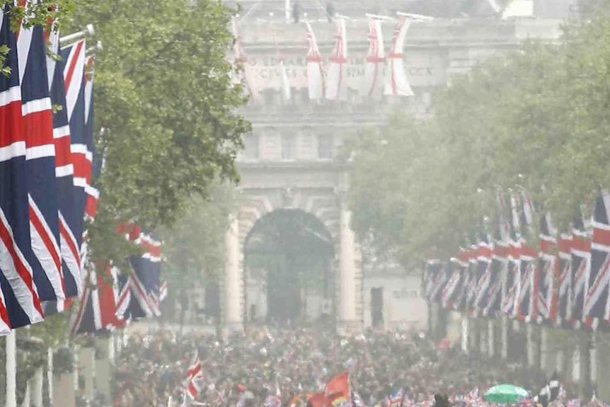Thousands pack The Mall as they wait for the Royal couple to appear