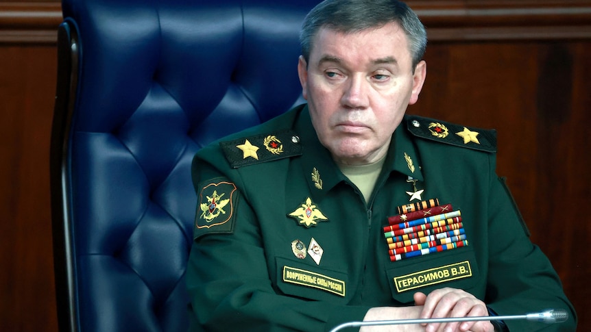 Valery Gerasimov sits at a desk wearing military uniform.