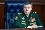 Valery Gerasimov sits at a desk wearing military uniform.