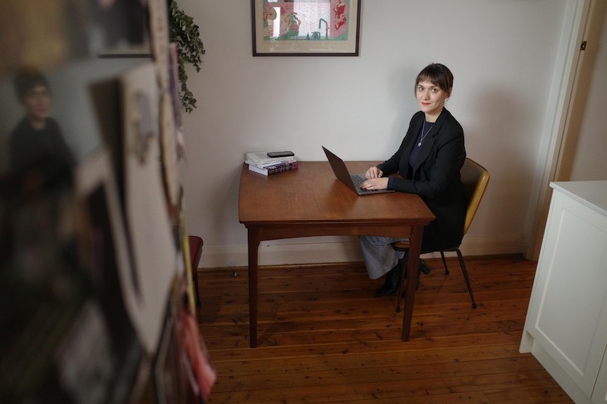 a woman at a laptop in a living room
