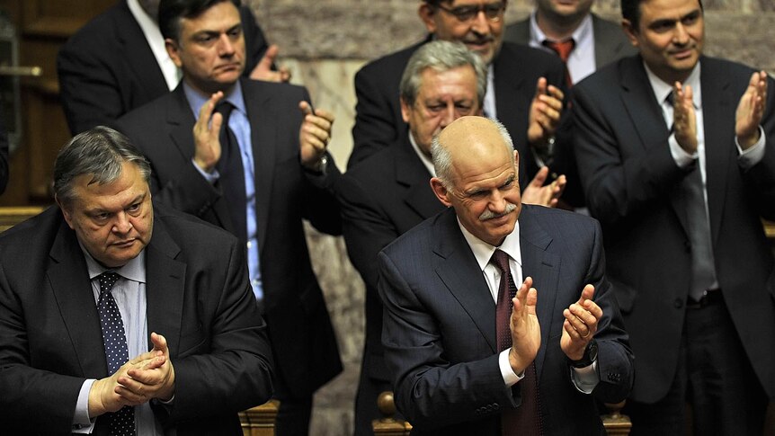 Mr Papandreou applauds alongside finance minister Evangelos Venizelos (L).