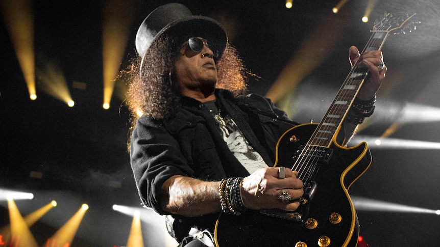 Close up photo of Slash, the guitarist for Guns N' Roses performing on stage