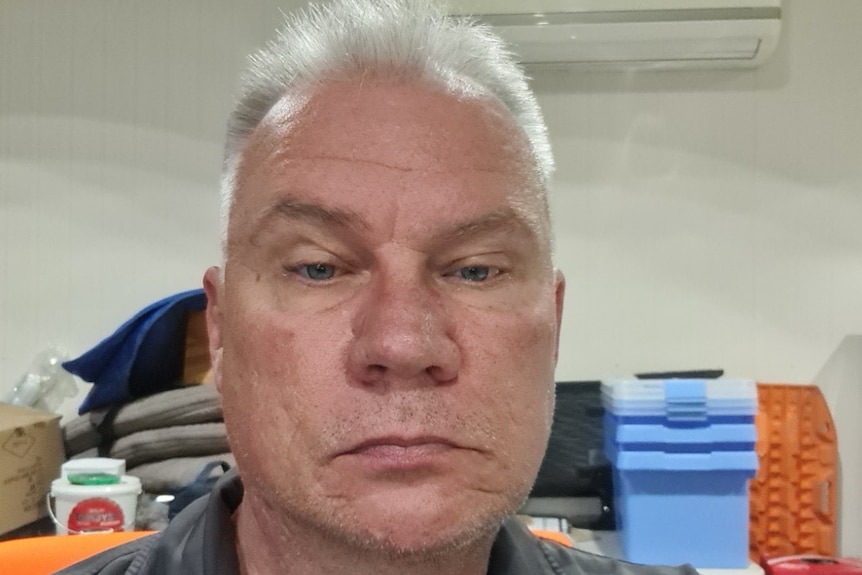 Man sitting in office with grey hair