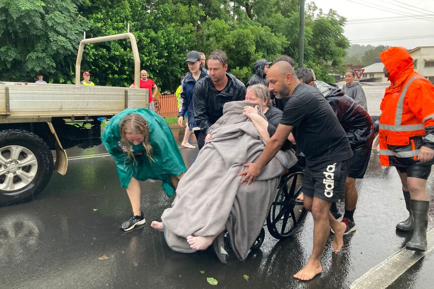 woman in wheelchair wheeled out of floodwaters 