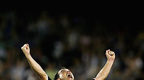 Kevin Muscat on his knees celebrating the A-League grand final