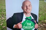 A corflute portraying independent Senate candidate David Pocock in a Greens T-shirt.