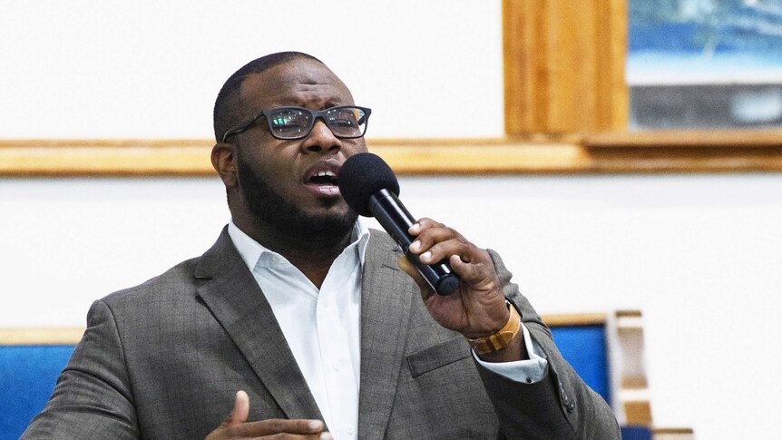 Botham Jean leading worship at a university presidential reception in Dallas.