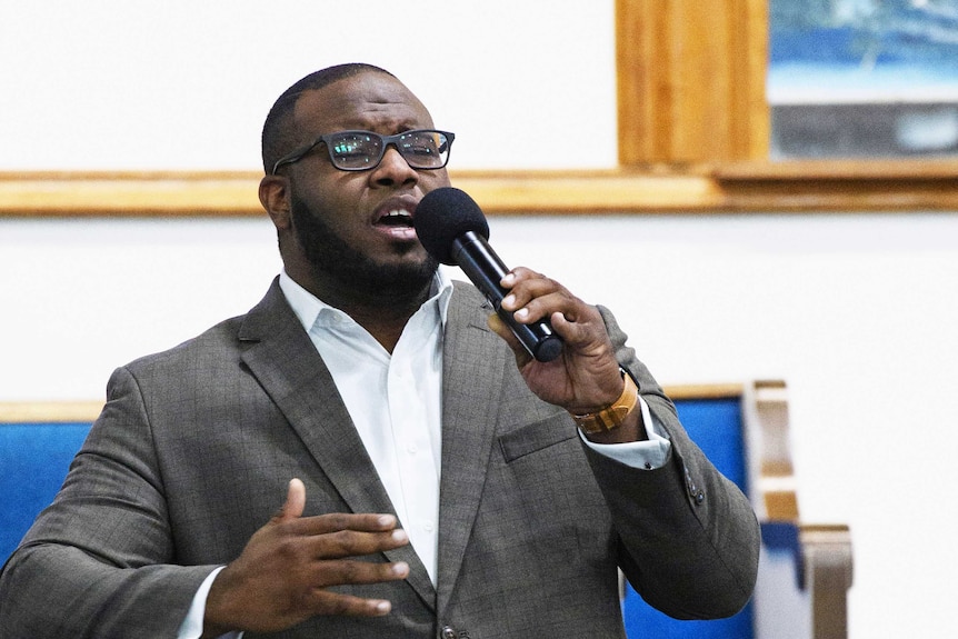 Botham Jean leading worship at a university presidential reception in Dallas.