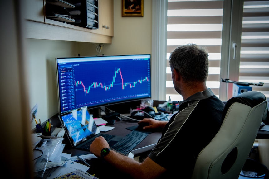 A man watching a stock ticker