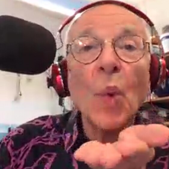 triple j presenter lucy smith and dr. karl blowing kisses to each other over a skype chat