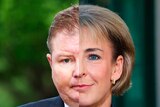 Half of Craig Laundy's head next to half of Michaelia Cash's head with a "Tranforming Cabinet" strap along the bottom.