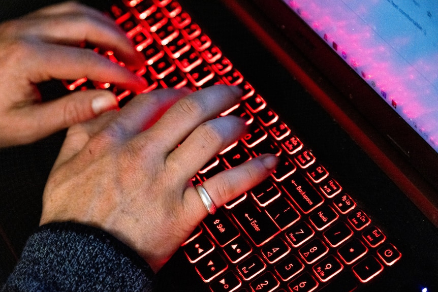 Hands on a laptop keyboard