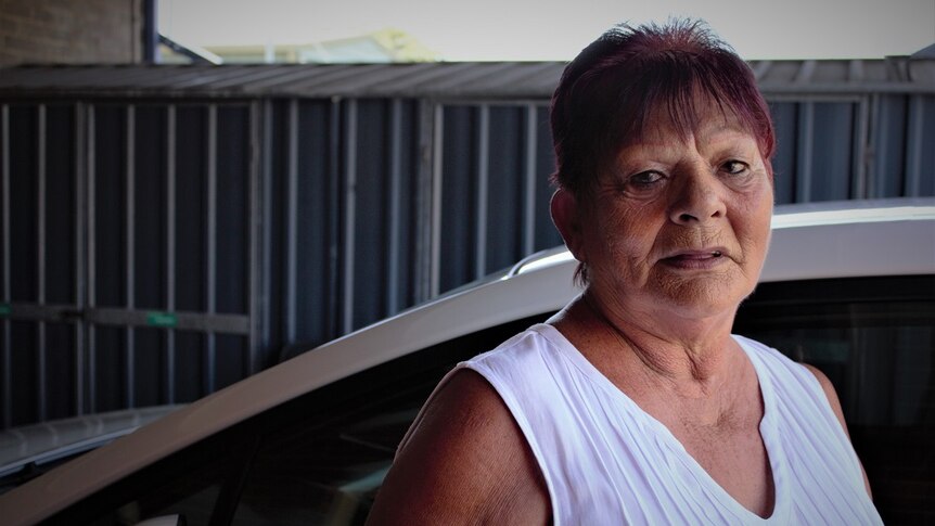 Bundjalung woman Shirley Stevenson stands next to a car