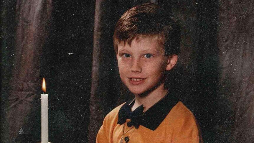 A young Jeff Horn takes holy communion.