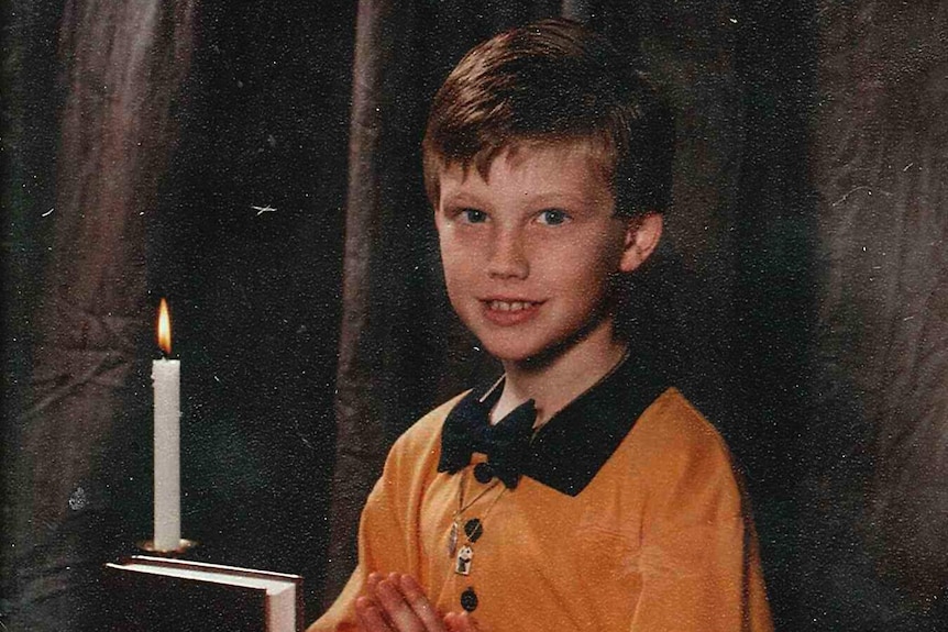 A young Jeff Horn takes holy communion.