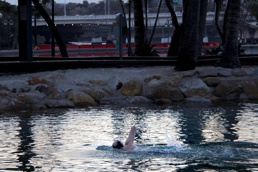 A man swims through the pools at the South Bank beach.