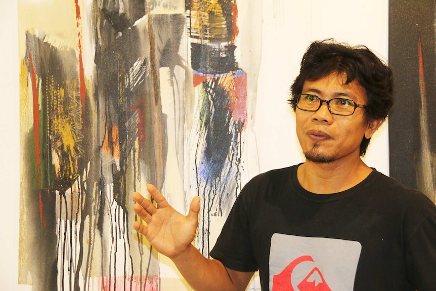 Wayan Wirawan, with his artwork 'The Mystery of Pukamani Poles'.